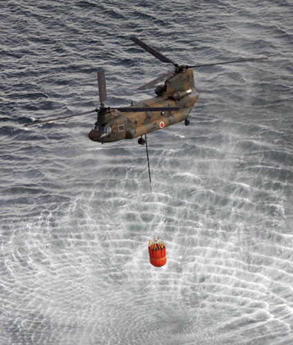 Choppers dump water on reactor